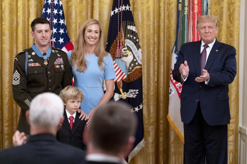 President Donald Trump applauds after awarding the Medal of Honor to Army Sgt. Maj. Thomas P. Payne as he stands with his wife Alison in the East Room of the White House, Friday, Sept. 11, 2020, in Washington. (AP Photo/Andrew Harnik)