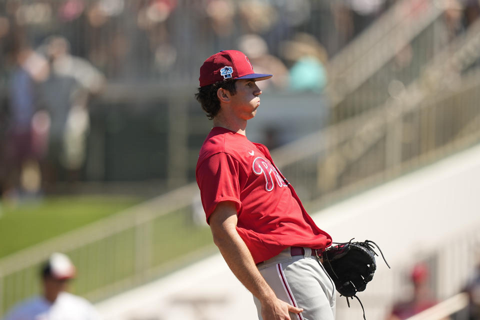 Philadelphia Phillies' pitcher Andrew Painter, reacts after he delivers in the first inning during a spring training baseball game against the Minnesota Twins, Wednesday, March 1, 2023, in Fort Myers, Fla. (AP Photo/Brynn Anderson)