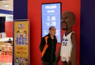 A man walks past the NBA Playzone at a shopping mall in Beijing