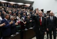 Turkish President Tayyip Erdogan greets members of parliament from his ruling AK Party as he arrives a meeting at the Turkish parliament in Ankara