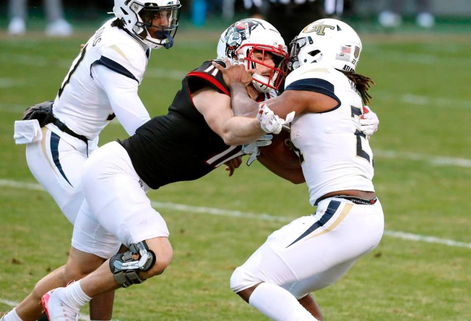 N.C. State linebacker Payton Wilson (11) tackles Georgia Tech running back Jordan Mason (27) for a loss during the Wolfpack’s game against Georgia Tech at Carter-Finley Stadium in Raleigh, N.C., Saturday, Dec. 5, 2020. In the game, Wilson led the team with 11 tackles despite playing with two dislocated shoulders.