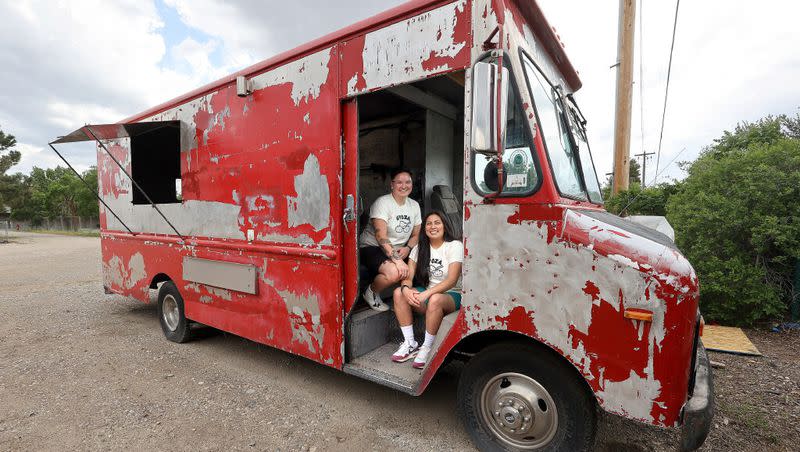 Ellie and Erika Yagi, co-owners of Yagi’s Dump Truck, pose for a portrait in their work-in-progress food truck, where they will sell dumplings, in Murray on Wednesday.