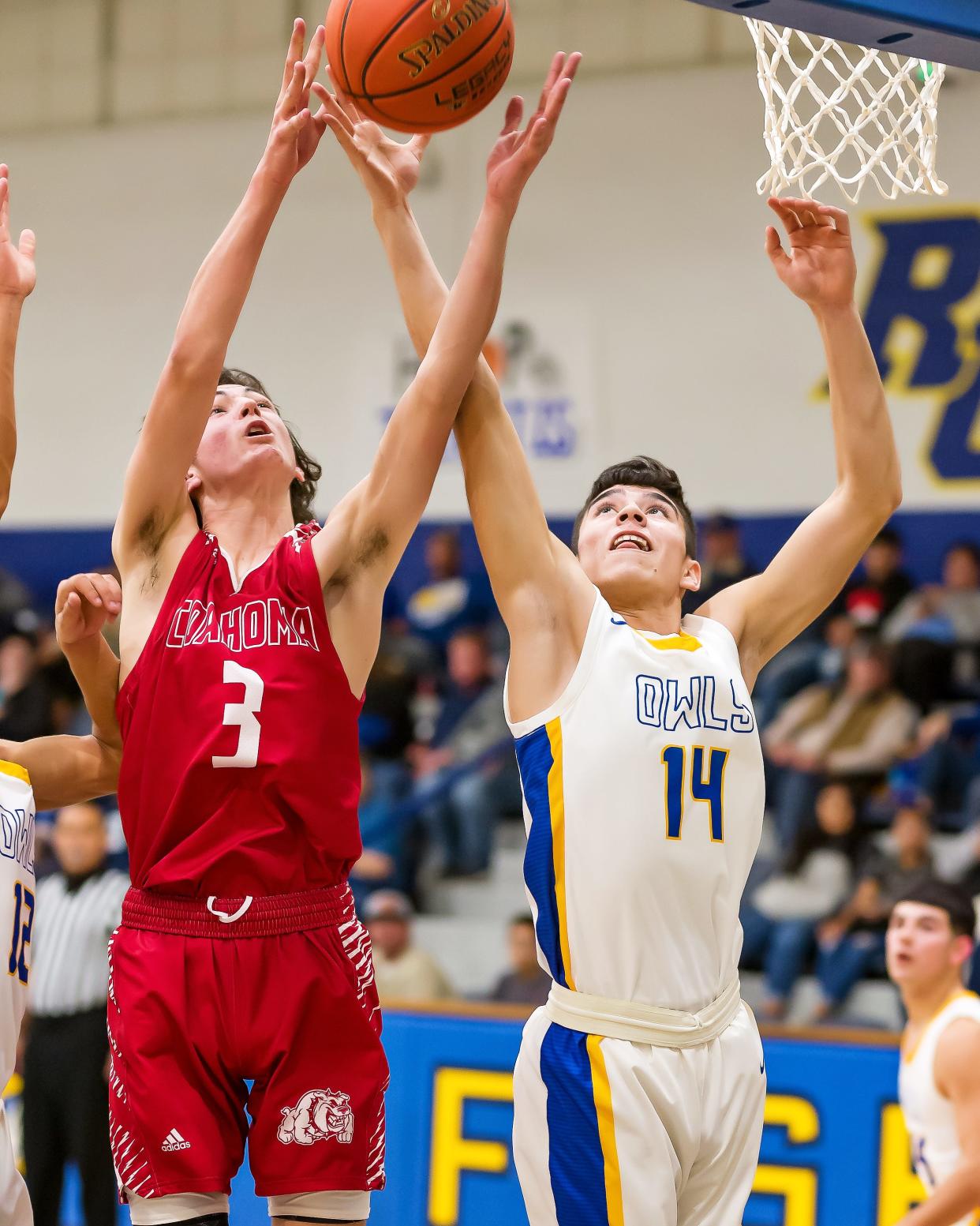 Reagan County's Elijah Gonzalez (14) and Coahoma's Ryan Shifflett (3) fight for a rebound Tuesday, Jan. 18, 2022, during the Owls' 61-24 win in Big Lake.