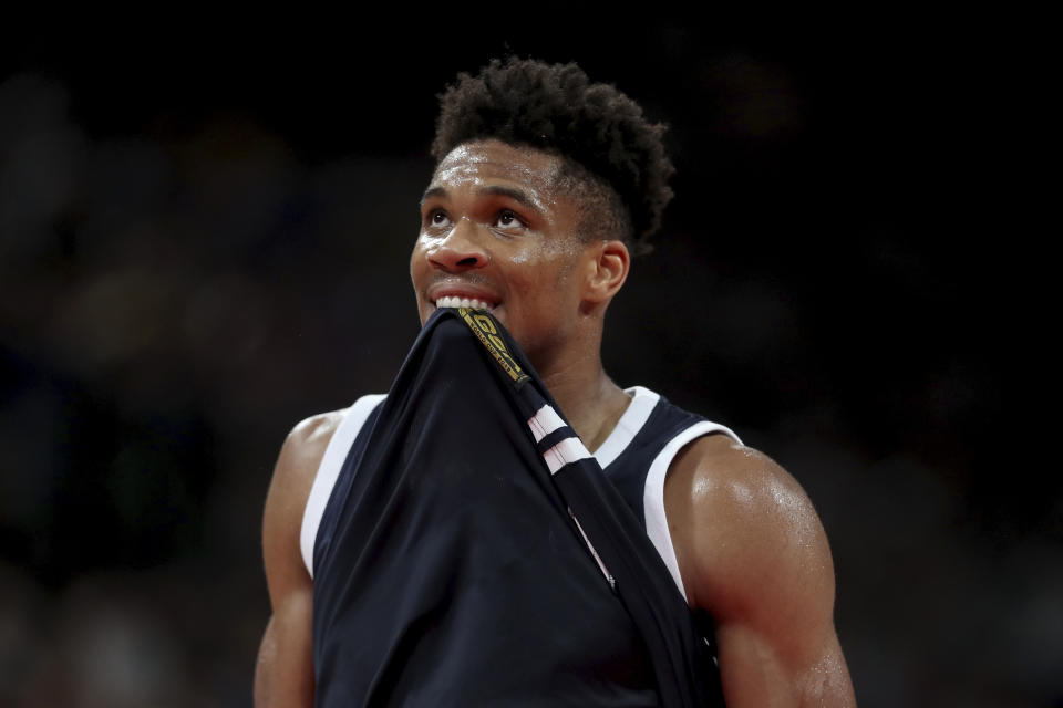 Greece's Giannis Antetokounmpo bites his jersey as he watches the clock during a phase two match against the United States for the FIBA Basketball World Cup at the Shenzhen Bay Sports Center in Shenzhen in southern China's Guangdong province on Saturday, Sept. 7, 2019. United States beats Greece 69-53. (AP Photo/Ng Han Guan)