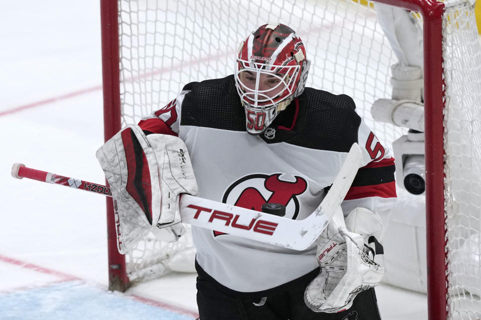 New Jersey Devils goaltender Nico Daws stops a shot by the Washington Capitals during the second period of an NHL hockey game in Washington, Wednesday, Jan. 3, 2024. (AP Photo/Susan Walsh)