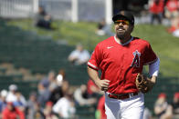 Los Angeles Angels' Anthony Rendon smiles as he runs to the dugout during the first inning of a spring training baseball game against the Cincinnati Reds, Tuesday, Feb. 25, 2020, in Tempe, Ariz. (AP Photo/Darron Cummings)