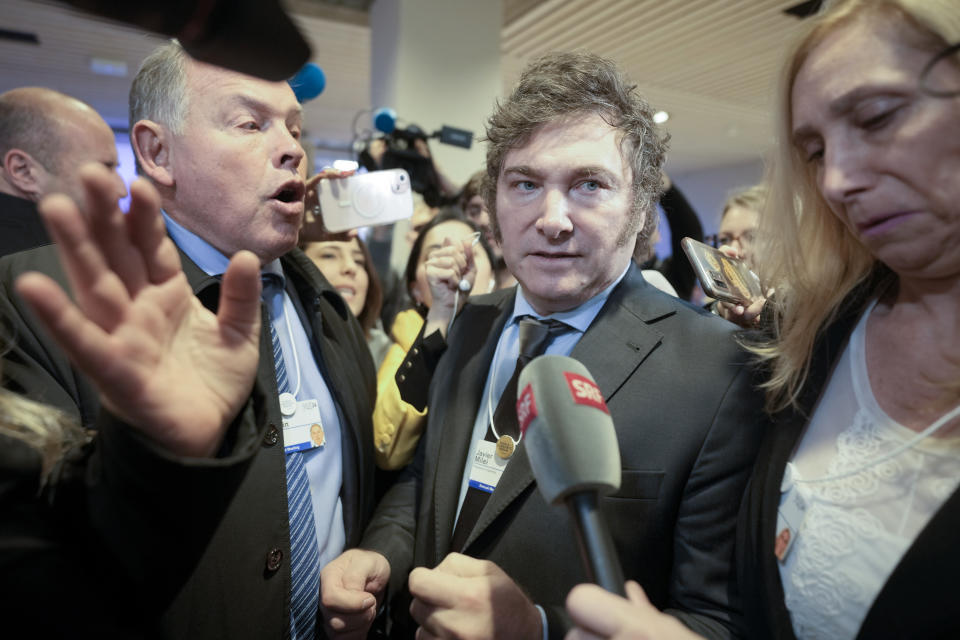 President of Argentina Javier Milei makes his way through the crowd of reporters and supporters after delivering his speech at the Annual Meeting of World Economic Forum in Davos, Switzerland, Wednesday, Jan. 17, 2024. The annual meeting of the World Economic Forum is taking place in Davos from Jan. 15 until Jan. 19, 2024.(AP Photo/Markus Schreiber)