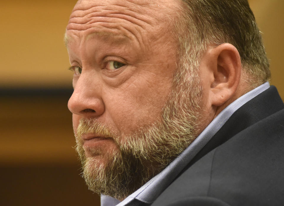 FILE - Infowars founder Alex Jones appears in court to testify during the Sandy Hook defamation damages trial at Connecticut Superior Court in Waterbury, Conn., on Thursday, Sept. 22, 2022. A six-person jury reached a verdict Wednesday, Oct. 12, 2022, saying that Jones should pay $965 million to 15 plaintiffs who suffered from his lies about the Sandy Hook school massacre. Jones and his company were found liable for damages last year. (Tyler Sizemore/Hearst Connecticut Media via AP, Pool, File)