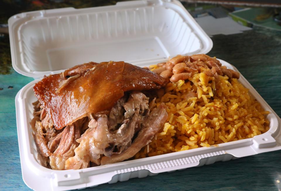 A medium size order of yellow rice with beans, and pork shoulder at Casa Campo on E. Main St. in Rochester Tuesday, Aug. 1, 2023.  Casa Campo will be serving the popular meal along with other traditional Puerto Rican dishes at the 53rd Puerto Rican Festival later this week. 