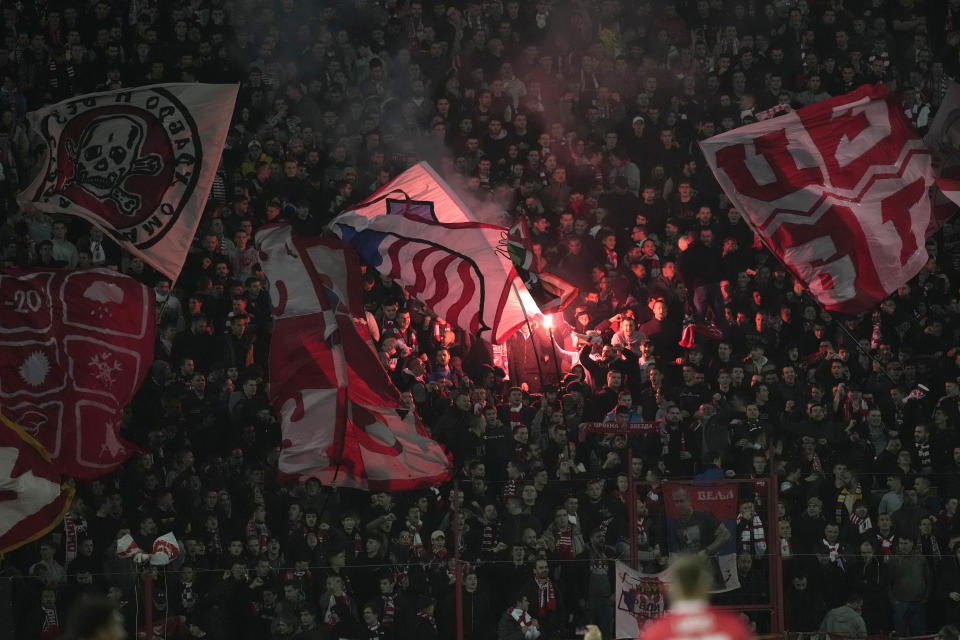 Red Star Belgrade supporters burn flares and hold flags during the Group G Champions League soccer match between Red Star and Manchester City, at the Rajko Mitic Stadium in Belgrade, Serbia, Wednesday, Dec. 13, 2023. (AP Photo/Darko Vojinovic)