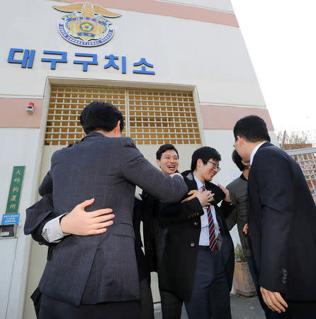 South Korean conscientious objectors celebrate after being released from Daegu detention center in Daegu, South Korea, November 30, 2018. Yonhap via REUTERS