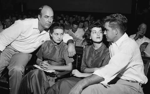 JW Milam, left, his wife, second left, Roy Bryant, far right, and his wife, Carolyn Bryant, sit together in a courtroom - Credit: AP