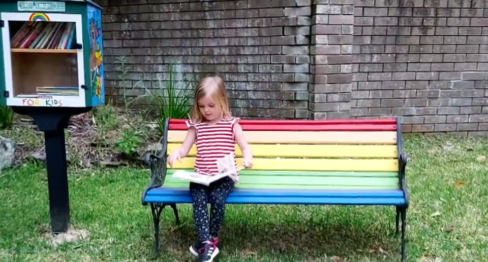 A girl sitting on the rainbow bench in St Ives. Source: 9 News. 