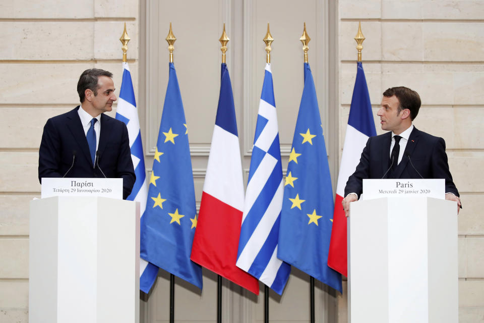 French President Emmanuel Macron, right, and Greek Prime Minister Kyriakos Mitsotakis attend a joint press conference at the Elysee Palace in Paris, Wednesday Jan. 29, 2020. (Benoit Tessier/Pool via AP)