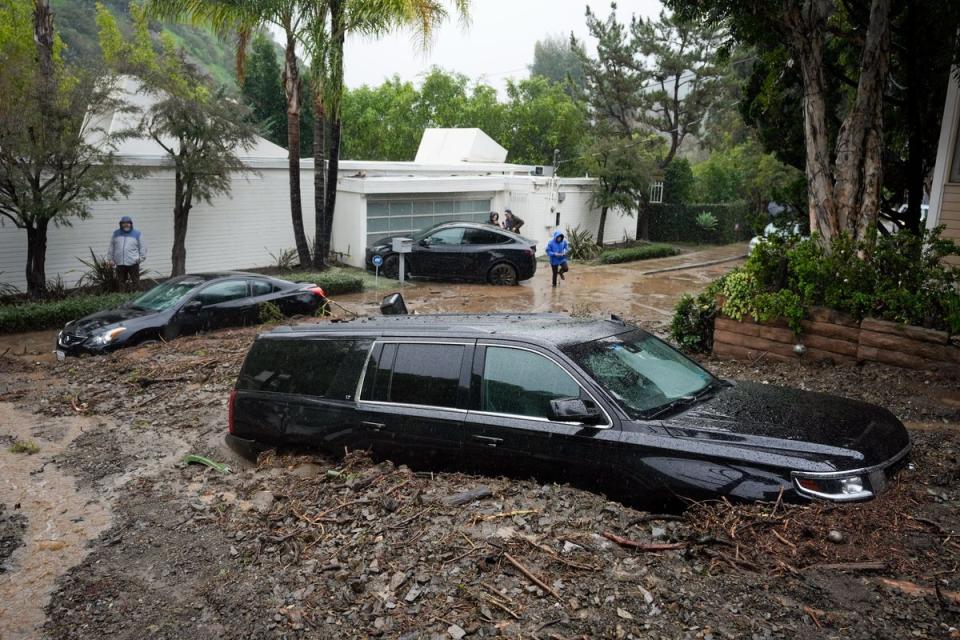 Cars sit buried by a mudslide (AP)