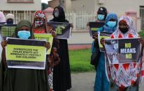 Protesters carry banners as they stage a demonstration to raise awareness about sexual violence in Abuja