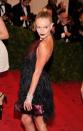 <p>For the Met Gala dedicated to “Prada: Impossible Conversations,” Kate Bosworth stood out in a flirty halter dress by the designer. The dark lip and top knot added some drama to the look. (Photo: Getty Images) </p>