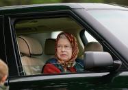 <p>A headscarf and Range Rover are Queen Elizabeth's Royal Windsor Horse Show essentials. The monarch drove to the 2005 show wearing maroon tones. </p>