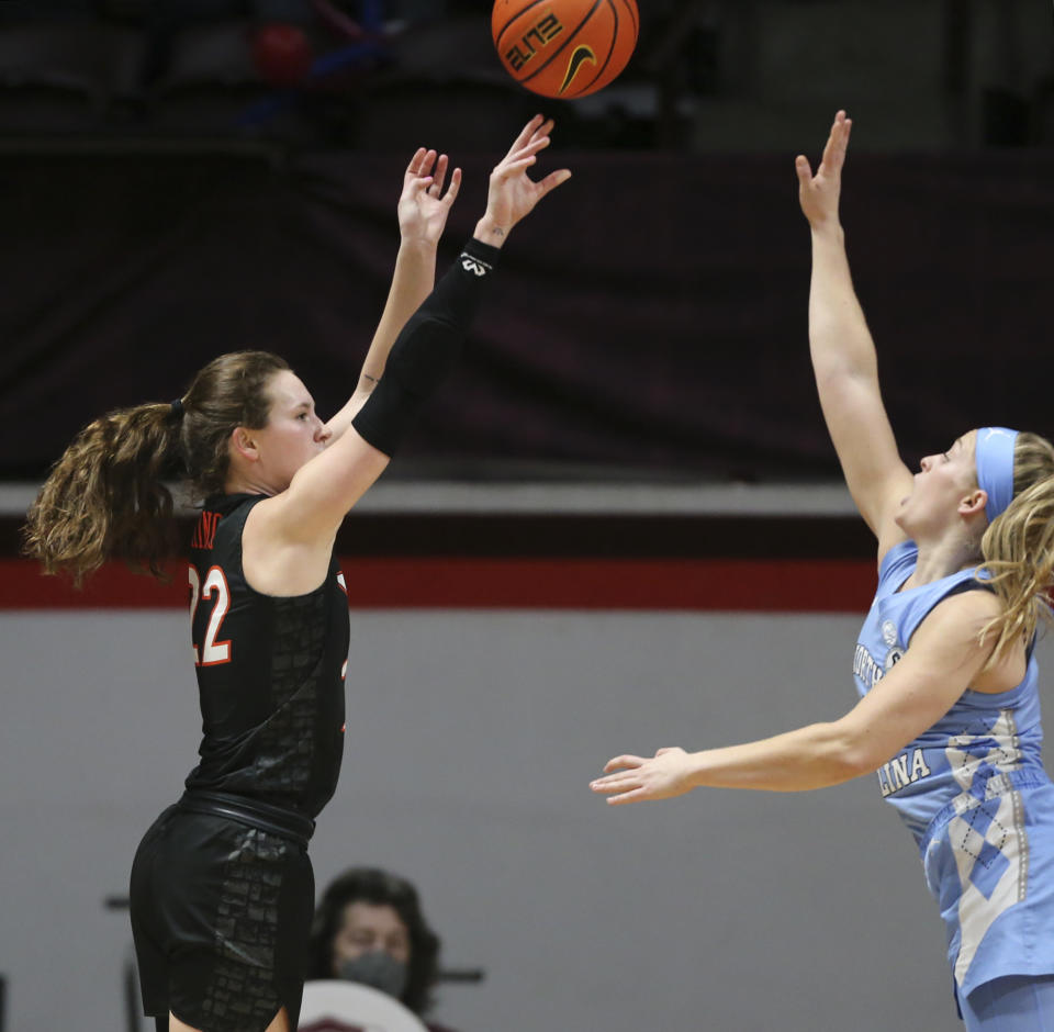 Virginia Tech's Cayla King (22) shoots a 3-point basket over North Carolina's Carlie Littlefield (2) in the first half of the North Carolina Virginia Tech women's NCAA basketball game in Blacksburg Va., on Saturday, Feb. 12 2022. (Matt Gentry/The Roanoke Times via AP)