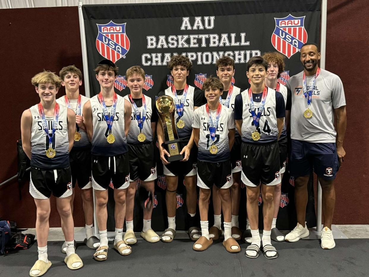 The Doylestown-based Total Skills 8th-grade team and head coach Jeremy Beckett (back row, right) show off their gold medals after winning the AAU World Championships in Orlando.