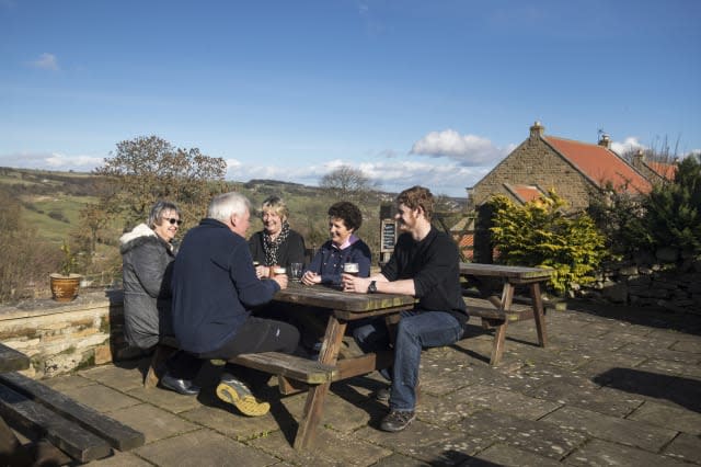 Embargoed to 0001 Friday March 3 Customers enjoy a drink in the beer garden at the George and Dragon pub in Hudswell, North Yorkshire, which has been crowned the CAMRA Pub of the Year.