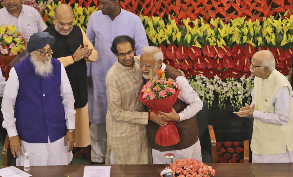 Indian Prime Minister Narendra Modi, center, hugs Uddhav Thackeray after being elected as Bharatiya Jananta Party and ruling alliance leader, in New Delhi, India, Saturday, May 25, 2019. BJP president Amit Shah announced Modi's name as the leader of the National Democratic Alliance in a meeting of the lawmakers in the Central Hall of Parliament in New Delhi, paving the way for Modi's second five-year term as prime minister after a thunderous victory in national elections. (AP Photo/Manish Swarup)