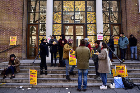 Protesters hold banners outside the University of London, Britain February 22, 2018. REUTERS/Peter Summers