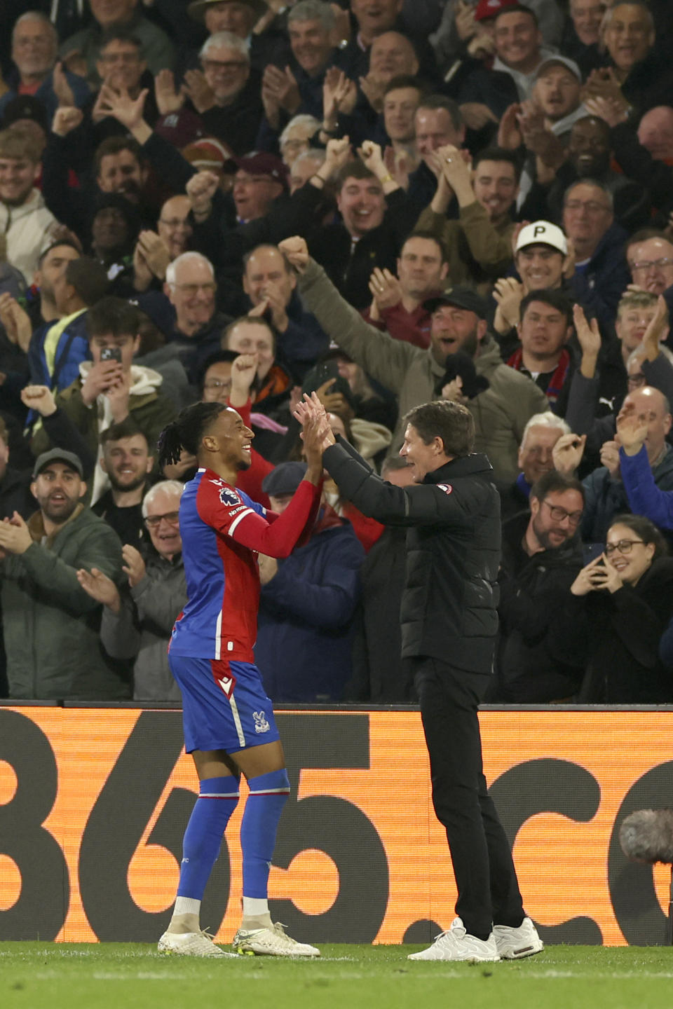Crystal Palace's Michael Olise celebrates with Crystal Palace manager Oliver Glasner after scoring his side's second goal during the English Premier League soccer match between Crystal Palace and Manchester United at Selhurst Park stadium in London, England, Monday, May 6, 2024. (AP Photo/Ian Walton)