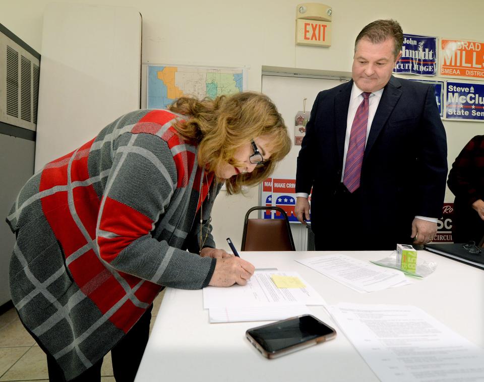 Sangamon County Republican Committee chairwoman Dianne Barghouti Hardwick signs the certificate of appointment of Mike Coffey as the 95th House District representative as Coffey watches Thursday.