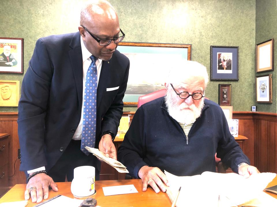 Kent Board of Education President Brian Boykin and Hometown Bank Chairman Howard Boyle examine early records of Spelman Chapel AME Church in Kent.