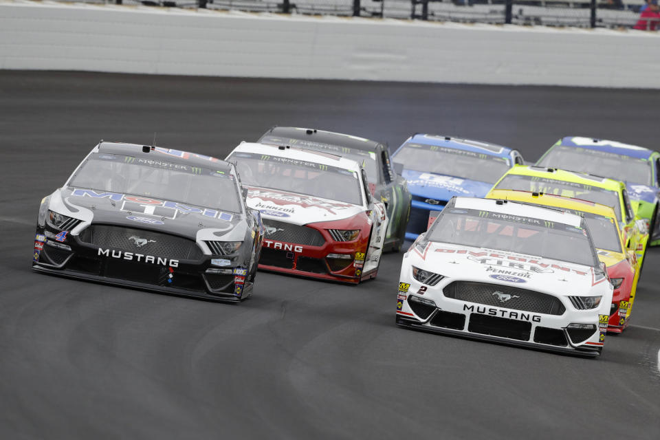 Kevin Harvick, left, and Brad Keselowski, right, drive through the first turn during the NASCAR Brickyard 400 auto race at Indianapolis Motor Speedway, Sunday, Sept. 8, 2019, in Indianapolis. (AP Photo/Darron Cummings)