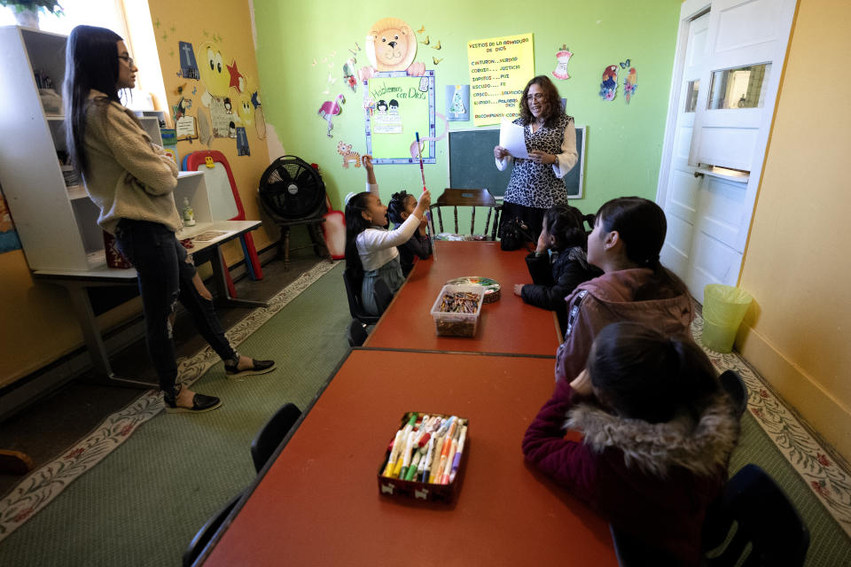 Angela Ramirez, top right, leads Sunday school for children of people attending a church service, Sunday, Dec. 17, 2023, in Fort Morgan, Colo. (AP Photo/Julio Cortez)