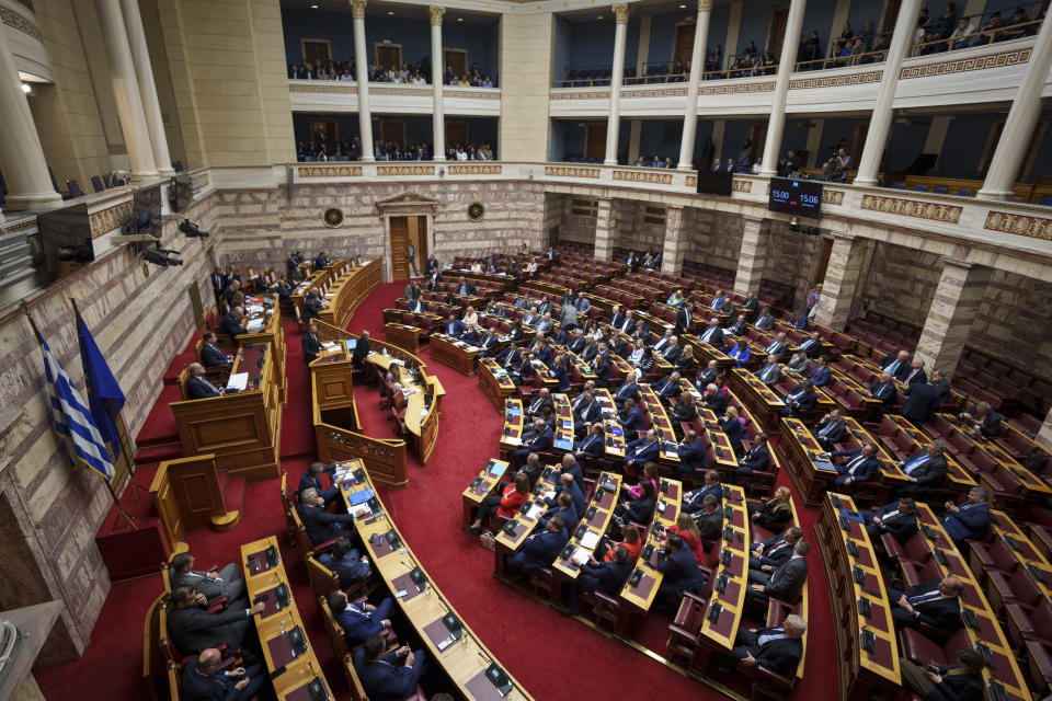 Lawmakers attend a parliament session in Athens, Greece, Thursday, March 28, 2024. A Greek opposition party Tuesday submitted a motion of no-confidence against the government, saying that it tried to cover up its responsibility over a deadly rail disaster last year that shocked Greece. The three-day debate in parliament is due to end with a vote late Thursday, March 28. (AP Photo/Petros Giannakouris)