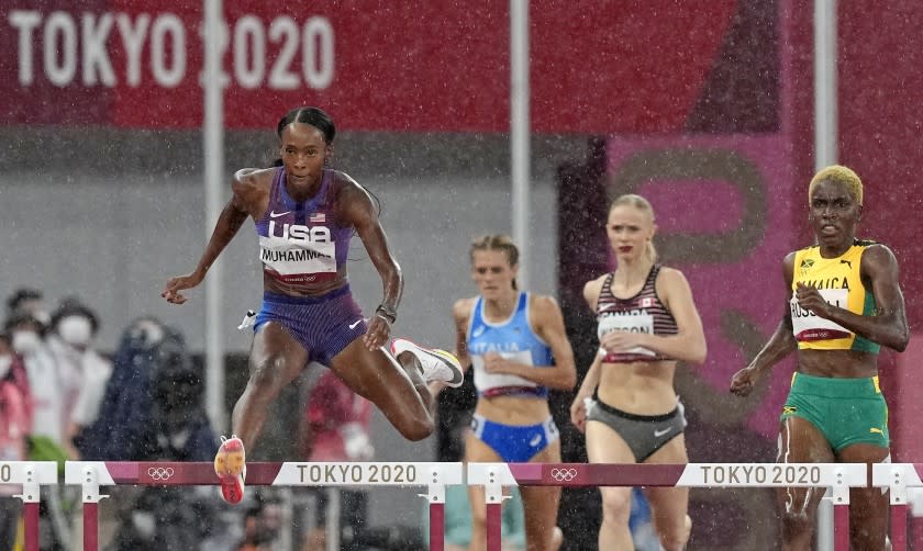 Dalilah Muhammad, of United States races to win a heat.