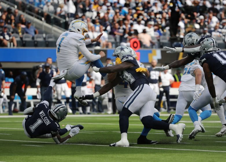 Dallas Cowboys defensive end Azur Kamara is charged with roughing the kicker on Los Angeles Chargers punter Ty Long