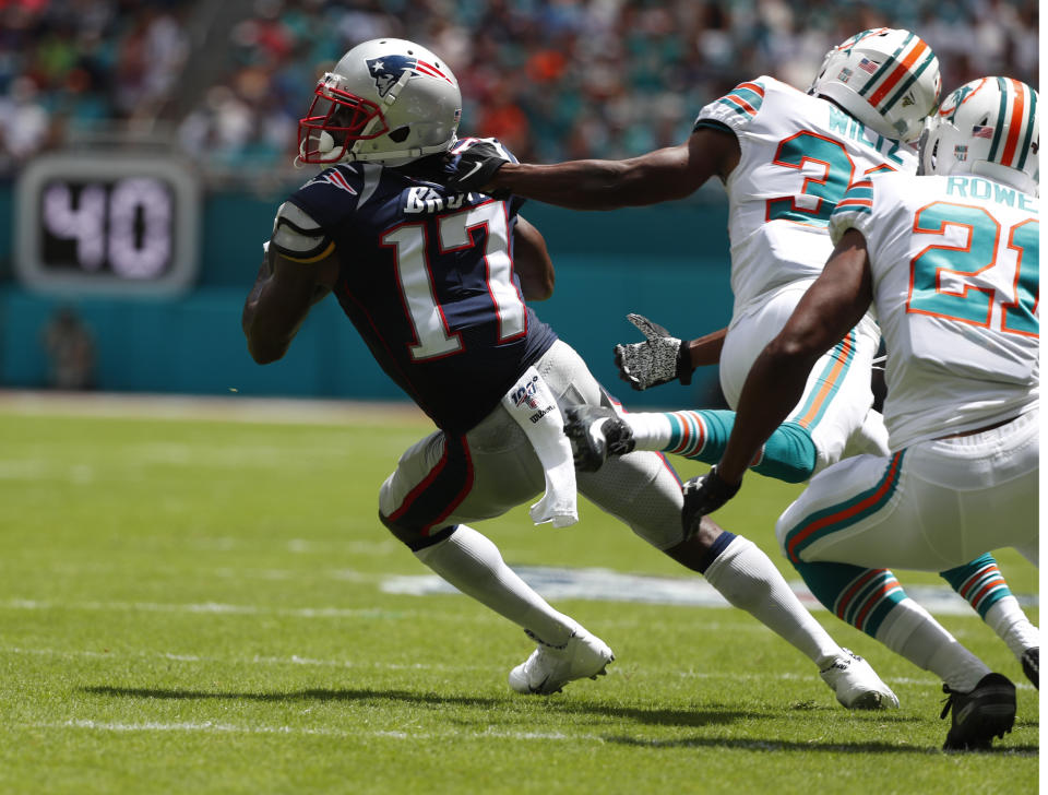 New England Patriots wide receiver Antonio Brown (17) gets away from Miami Dolphins cornerbacks Jomal Wiltz (33) and Miami Dolphins cornerback Eric Rowe (21) during the first half of an NFL football game against the Miami Dolphins, Sunday, Sept. 15, 2019, in Miami Gardens, Fla. (AP Photo/Wilfredo Lee)