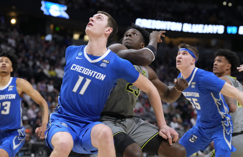 Creighton center Ryan Kalkbrenner, left, and Baylor forward Jonathan Tchamwa Tchatchoua wait for a rebound during the first half of a second-round college basketball game in the men's NCAA Tournament on Sunday, March 19, 2023, in Denver. (AP Photo/David Zalubowski)