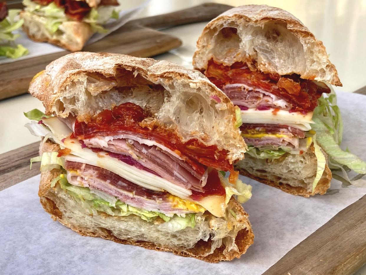 Halved Italian sandwich on a cutting board