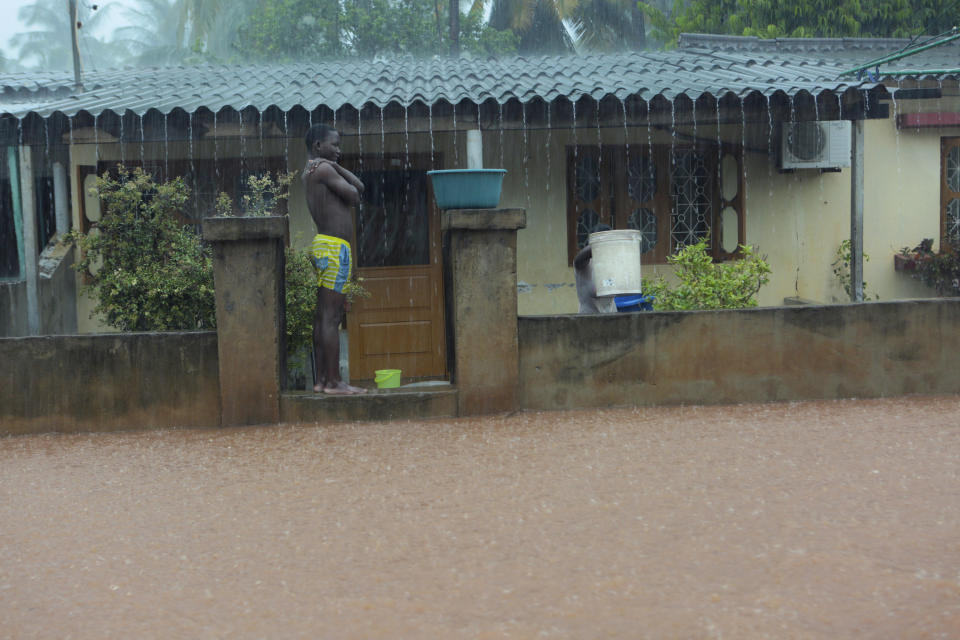 A young boy takes a break from scooping water from his family home, in Natite neighbourhood, in Pemba, on the northeastern coast of Mozambique, Sunday, April, 28, 2019. Serious flooding began on Sunday in parts of northern Mozambique that were hit by Cyclone Kenneth three days ago, with waters waist-high in areas, after the government urged many people to immediately seek higher ground. Hundreds of thousands of people were at risk. (AP Photo/Tsvangirayi Mukwazhi)