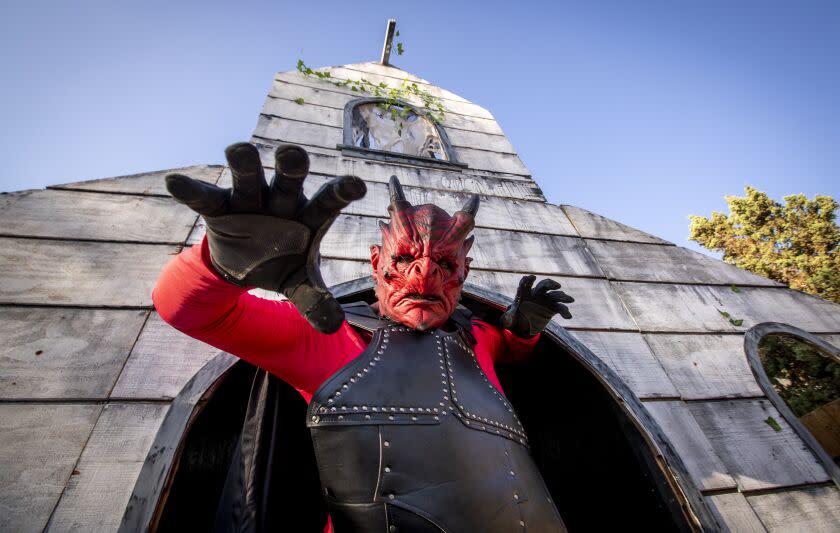 Santa Ana, CA - October 04: Joshua "Screwloose" Shibley is in costume as "Satan" at Jesus "Chewie" Garcia's beginning stages of his halloween haunted house called Santa Ana Haunt, resembling a church that is instead a doorway to hell at Garcia's father's home in Santa Ana, Tuesday, Oct. 4, 2022. As local spooky season has stretched in recent years, SoCal's elaborate amateur "home haunts" have grown to a major cottage industry, with longtime haunters predicting record crowds in 2022. Garcia is a relative newcomer to the scene. (Allen J. Schaben / Los Angeles Times)