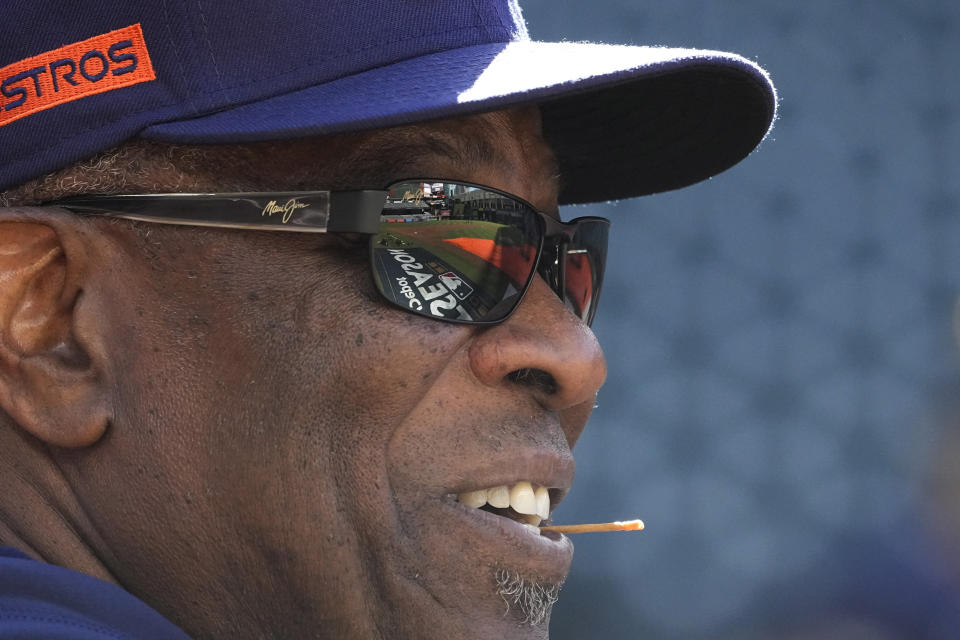 The MLB Post Season logo is reflected in the sunglasses of Houston Astros manager Dusty Baker Jr. during a practice ahead of Game 1 of baseball's American League Championship Series, in Houston, Tuesday, Oct. 18, 2022. (AP Photo/Eric Gay)
