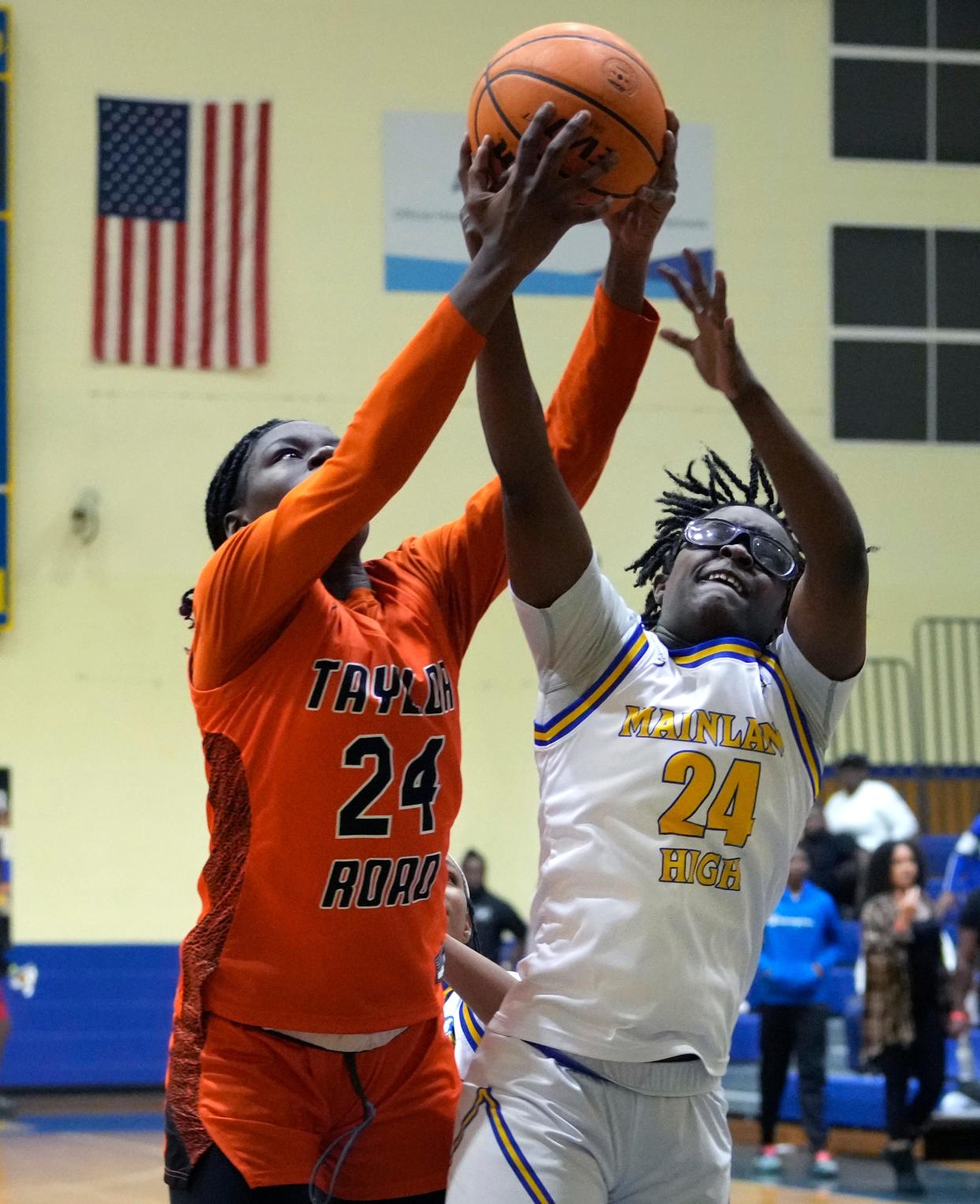 Mainland's Jordan Boddie battles for the ball with Spruce Creek's Yanija Lawson during a game at Mainland High School, Wednesday, Dec. 21, 2022.