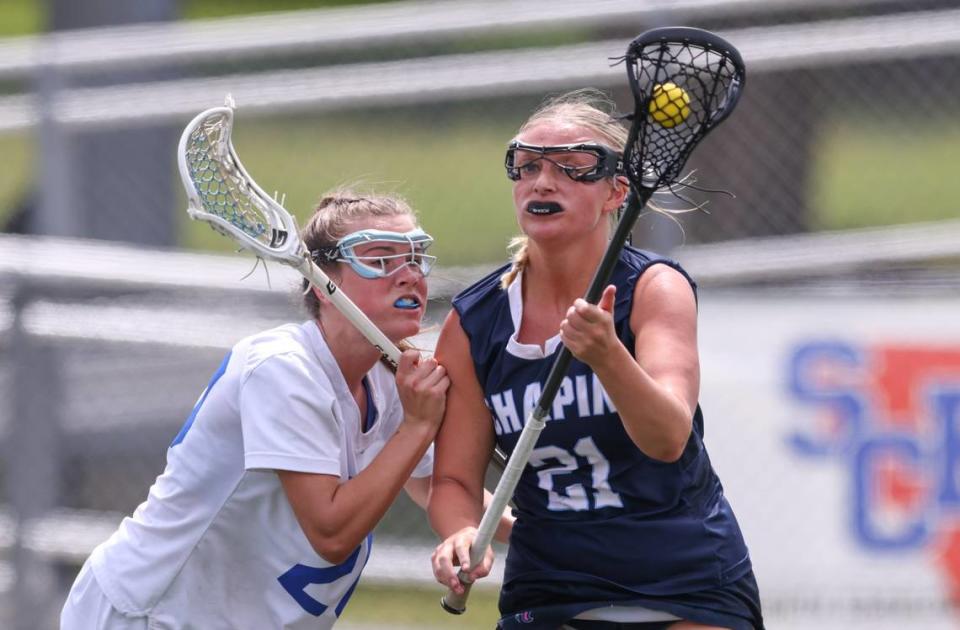 Jules Brown (21) of Chapin is defended by Molly Bennett (20) of Fort Mill during the SCHSL Girls Lacrosse State Championship between Chapin and Fort Mill at Irmo High School in Irmo on Saturday, April 27, 2024.