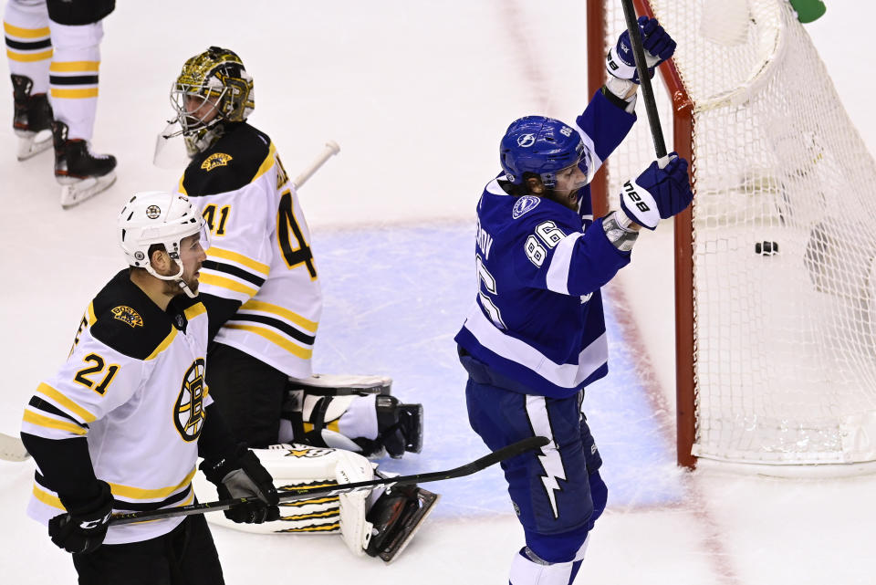 Tampa Bay Lightning right wing Nikita Kucherov (86) celebrates after scoring on Boston Bruins goaltender Jaroslav Halak (41) as Bruins left wing Nick Ritchie (21) watches during the second period of Game 2 of an NHL hockey second-round playoff series, Tuesday, Aug. 25, 2020, in Toronto. (Frank Gunn/The Canadian Press via AP)