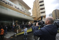 Journalists gather outside the Lebanese Journalists Syndicate where ex-Nissan chief Carlos Ghosn is scheduled to hold a press conference, in Beirut, Lebanon, Wednesday, Jan. 8, 2020. The disgraced former chairman of Nissan is expected to speak to journalists in Beirut, more than a week after his dramatic escape from Japan ahead of his trial for alleged financial misconduct. (AP Photo/Hussein Malla)