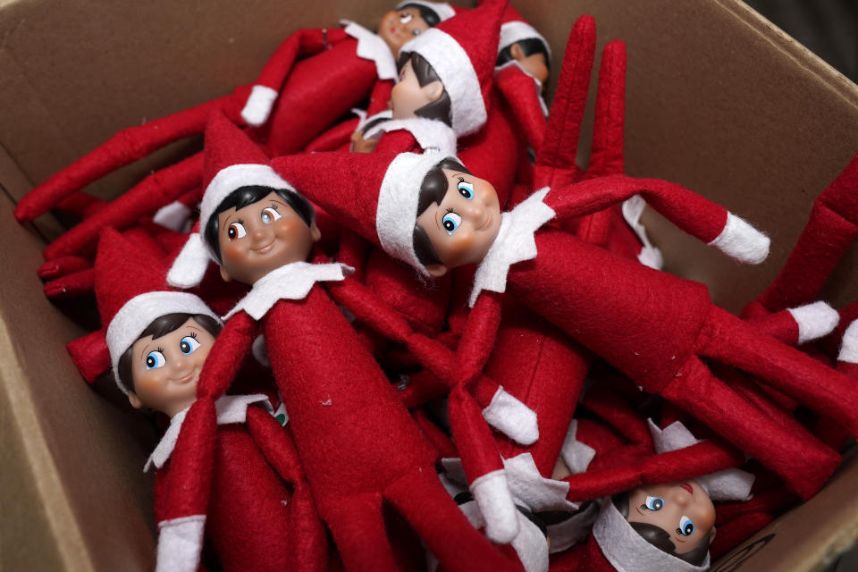 Elf on the Shelf figures are piled in a box at the company's studio Thursday, Aug. 27, 2020, in Atlanta. Thousands of suppliers routinely rely on credit insurance to cover potential losses if any of the retailers they work with can’t pay for the goods they’ve ordered. But now insurers are scaling back on coverage because they are unwilling to take a chance on retailers that are struggling to survive during the pandemic. Christa Pitts, founder and co-CEO of The Lumistella Company, which produces toys, books and other products under the Elf on the Shelf and Elf Pets brands, says her retail orders were covered 100% before the pandemic. Now, only 50% are covered, forcing her to rethink who she will sell to. (AP Photo/John Bazemore)