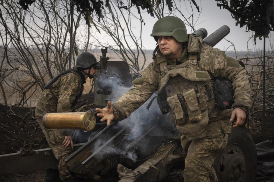 FILE - Ukrainian soldiers with the 71st Jaeger Brigade fire a M101 howitzer at Russian positions on the front line, near the city of Avdiivka in Ukraine's Donetsk region, on March 22, 2024. Approval by the U.S. House of a $61 billion package for Ukraine puts the country a step closer to getting an infusion of new firepower. But the clock is ticking. Russia is using all its might to achieve its most significant gains since the invasion by a May 9 deadline. (AP Photo/Efrem Lukatsky, File)