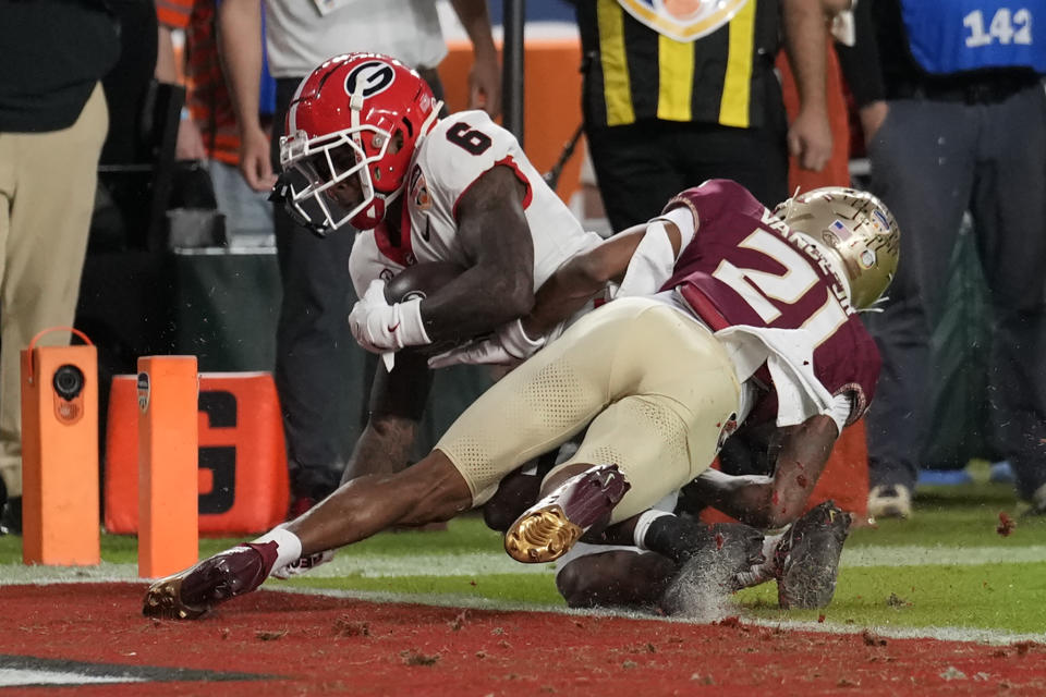 Georgia wide receiver Dominic Lovett (6)scores a touchdown past Florida State defensive back Greedy Vance Jr. (21) in the first half of the Orange Bowl NCAA college football game, Saturday, Dec. 30, 2023, in Miami Gardens, Fla. (AP Photo/Rebecca Blackwell)
