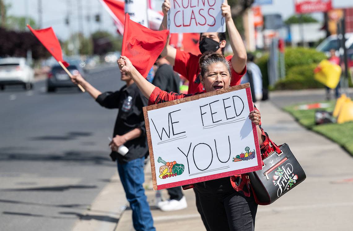 Maria Castillo calls out to motorists during a United Farm Workers rally in Ceres calling on Gov. Newsom to support the Agricultural Labor Relations Voting Choice Act which would allow farm workers to vote by mail in union elections. Photographed on Hatch Road in Ceres, Calif., on Thursday, March 31, 2022.