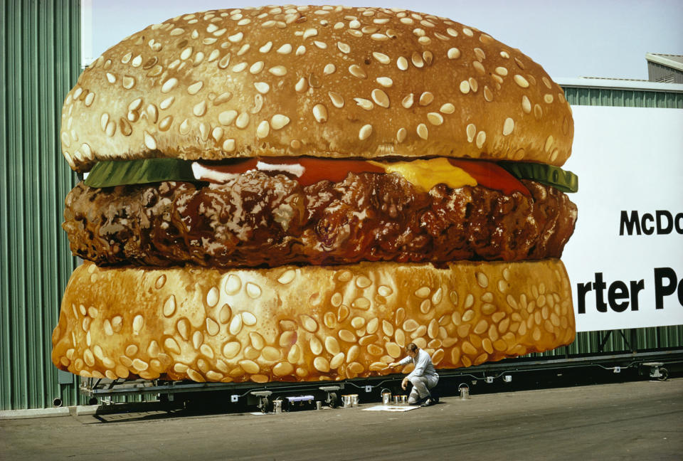 a man painting a billboard